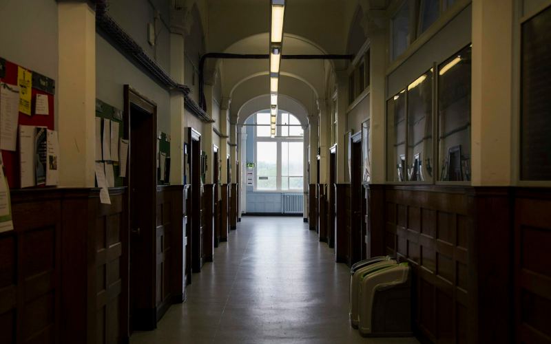 School corridor with noticeboards and lockers